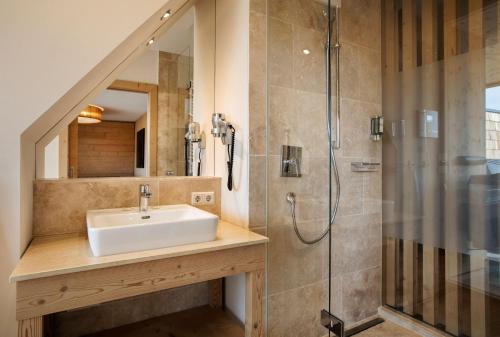 a bathroom with a sink and a shower at Almwellness Hotel Pierer in Fladnitz an der Teichalm