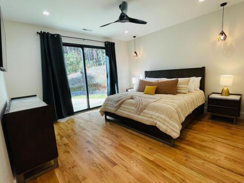 a bedroom with a bed and a ceiling fan at The Bungalow at Valley Bear Farms Resort in Balsam Grove