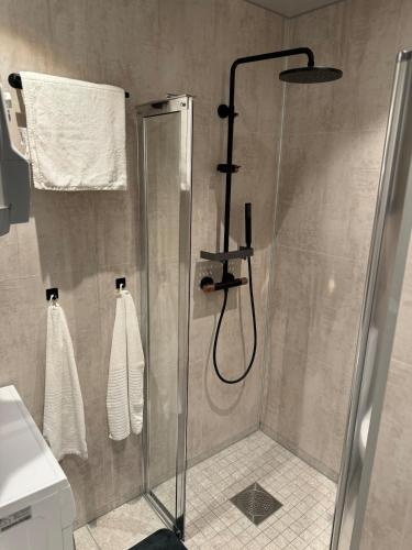a shower in a bathroom with a glass shower stall at FjordView in Stranda