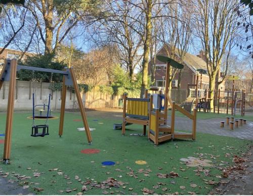 a park with a playground with a slide at Child favorite coach house city villa tilburg in Tilburg