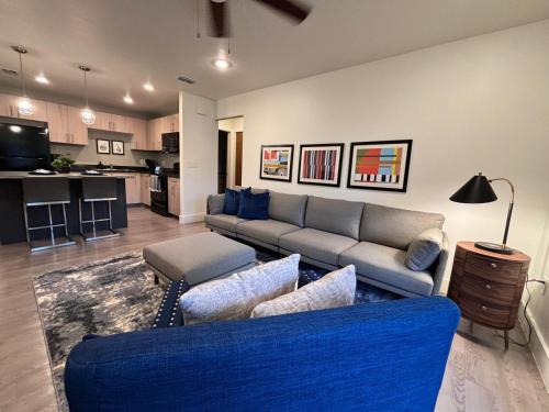 a living room with a blue couch and a kitchen at Wildrose Villas in Brownsville