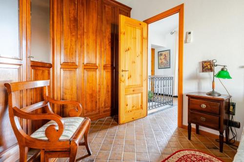 a room with a chair and a wooden door at Sea-View Retreat - Pool, Tavern, Fireplace in Rapallo