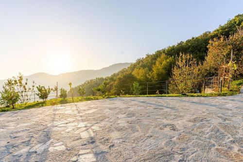 an empty road with mountains in the background at Sea-View Retreat - Pool, Tavern, Fireplace in Rapallo