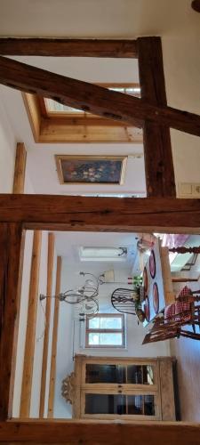 a room with a wooden ceiling with a chandelier at Haus zur alten Bimmelbahn in Kurort Jonsdorf