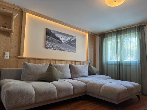 a living room with a couch and a window at Haus Angelika in Vandans