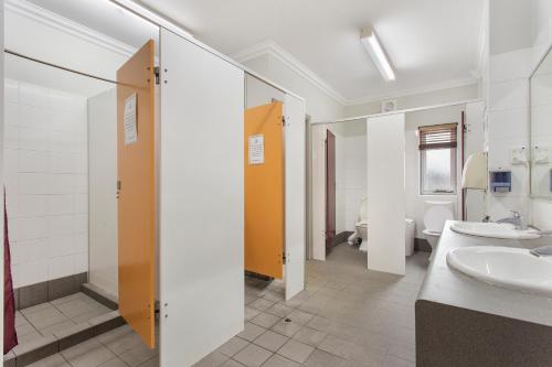 パースにあるThe Emperors Crown Hostelの洗面台2つとトイレ2つを備えたバスルーム