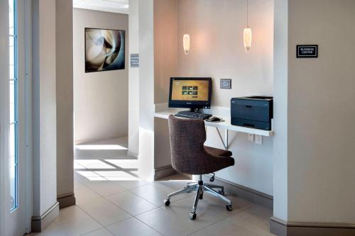 an office with a desk with a computer and a chair at Residence Inn Cranbury South Brunswick in Cranbury