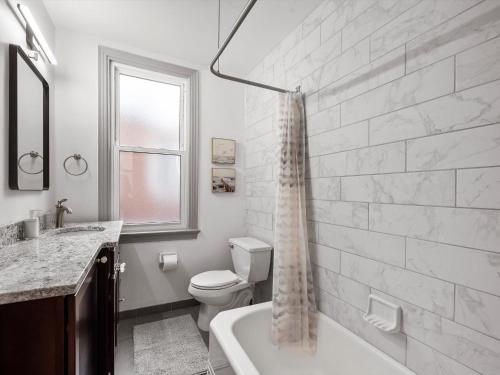 a bathroom with a tub and a toilet and a sink at Oakland, Pittsburgh !B Stylish and Quiet Private Bedroom with Shared Bathroom in Pittsburgh
