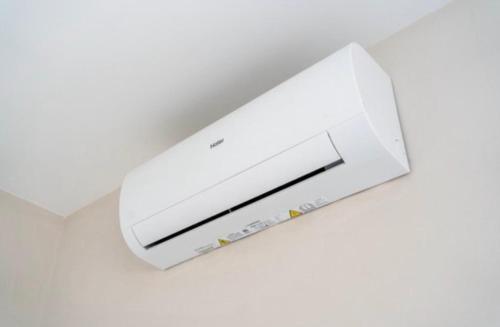 a white air conditioner hanging from a ceiling at 2 bedroom apartment in gudja in Gudja