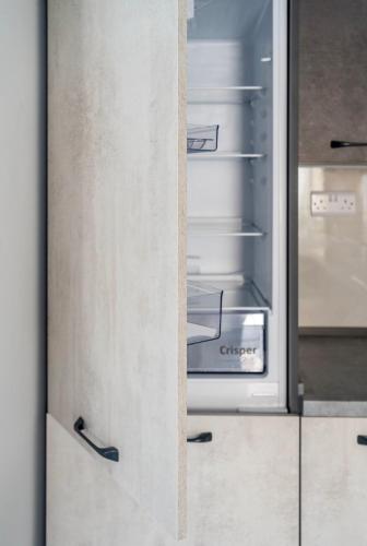 an empty refrigerator with its door open in a kitchen at 2 bedroom apartment in gudja in Gudja