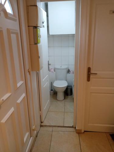 a small bathroom with a toilet and a window at Light Side Self Checkin available in Sarcelles