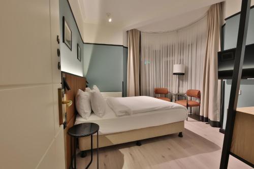 A bed or beds in a room at EA Exclusive Hotel