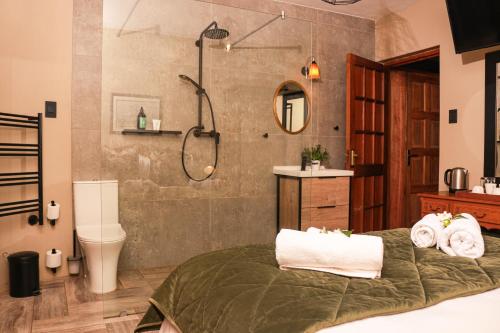 a bathroom with a shower and a bed and a sink at Diamantvallei Landgoed in Rayton