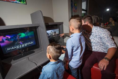 a group of people playing a video game on the wii at Gladstone Reef Hotel Motel in Gladstone