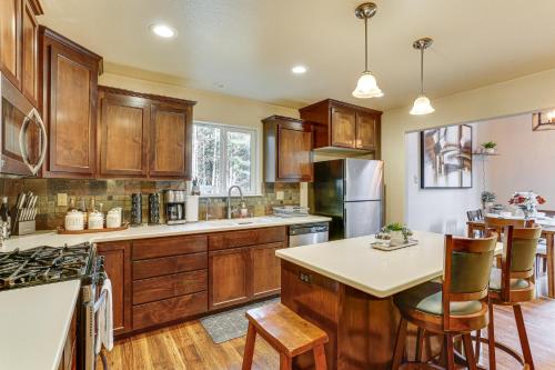 a kitchen with wooden cabinets and a kitchen island at Private Cabin with Forest Views and Grill in Lakehead! in Lakehead