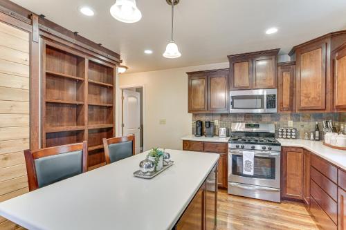 a kitchen with wooden cabinets and a white counter top at Private Cabin with Forest Views and Grill in Lakehead! in Lakehead