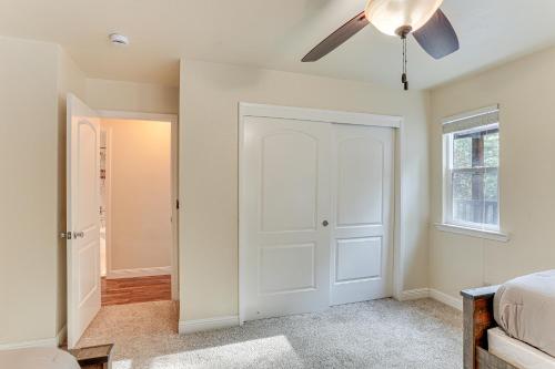 a bedroom with a white door and a ceiling fan at Private Cabin with Forest Views and Grill in Lakehead! in Lakehead
