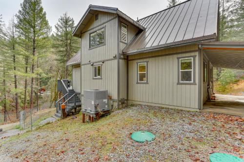 a house with a large yard in front of it at Private Cabin with Forest Views and Grill in Lakehead! in Lakehead