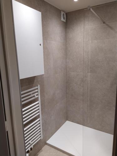 a bathroom with a shower with a glass door at Residentie Rapallo in Middelkerke