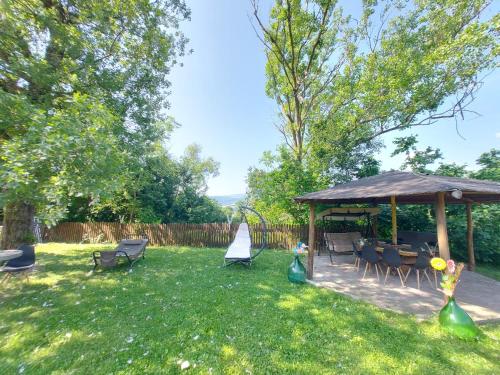 a gazebo with chairs and tables in a yard at Casa Campomonte in Poppi