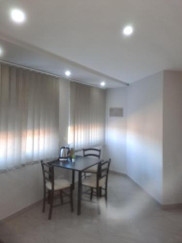 a dining room with a table and chairs at Lena lux in Jagodina