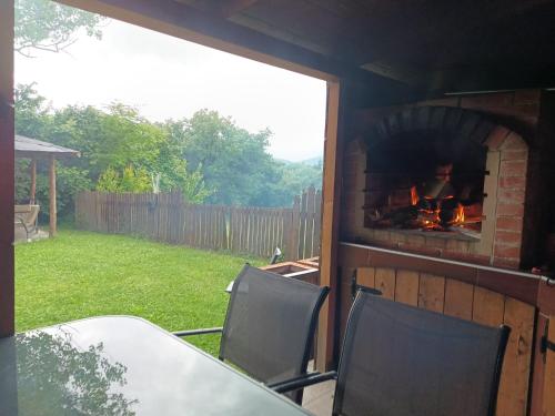 a patio with a fireplace with a table and chairs at Casa Campomonte in Poppi