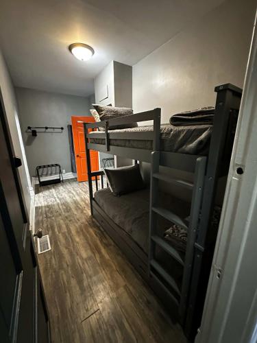a room with two bunk beds and a couch at 1 Mile From Boyne Mt- Chateau Patak in Boyne Falls