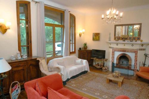 a living room with a couch and a fireplace at La Chaumière, Formule maison entière in Colmars