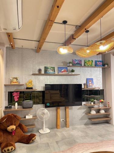 a large teddy bear sitting in a living room at Chomchom Pool Villa in Hua Hin