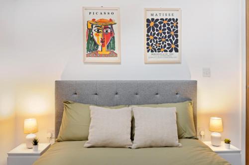a bedroom with a bed with two posters on the wall at Bright and Modern 2-bed Home in Newark on-Trent by Renzo, Free Parking, Sleeps 5! in Newark upon Trent