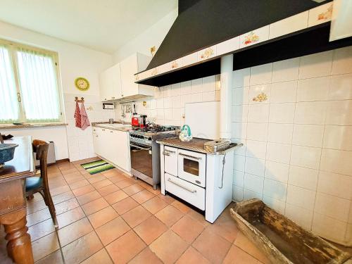 a kitchen with a stove and a sink in it at CàGrande in Colombara