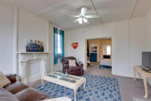a living room with a couch and a table at 9 Mi to Downtown St Louis Apt with Fire Pit Access in Bella Villa