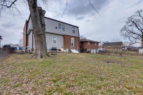 a house with a tree in the yard at 9 Mi to Downtown St Louis Apt with Fire Pit Access in Bella Villa