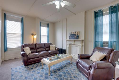 a living room with two leather couches and a coffee table at 9 Mi to Downtown St Louis Apt with Fire Pit Access in Bella Villa