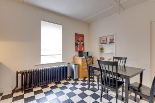 a dining room with a table and chairs and a radiator at 9 Mi to Downtown St Louis Apt with Fire Pit Access in Bella Villa