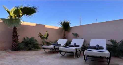 a group of chairs sitting on a patio at Villa Palms de l'Atlas in Marrakech
