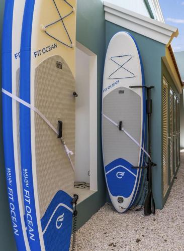 two surfboards are leaned up against a wall at Casa Blue Marlin in Kralendijk