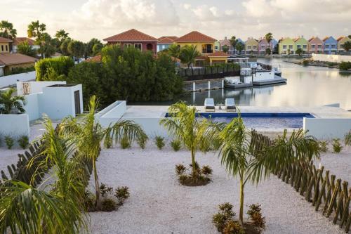arial view of a resort with palm trees and a marina at Casa Blue Marlin in Kralendijk