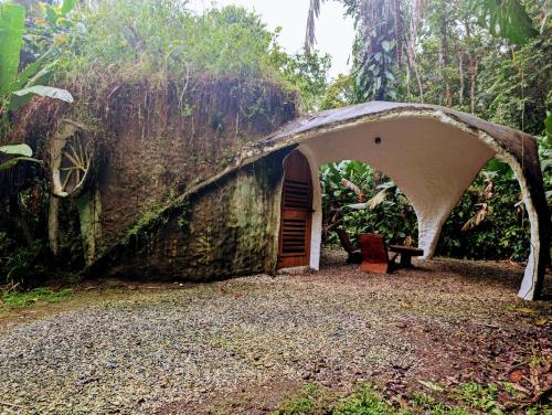 an old house in the woods with an archway at Danta Corcovado Lodge in Rincón