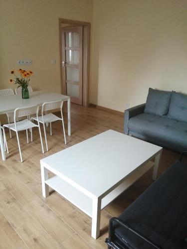 a living room with a couch and a table at Kwatera agroturystyczna Przywóz in Przywóz