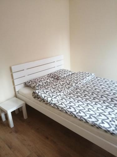 a bedroom with a bed and a chair next to it at Kwatera agroturystyczna Przywóz in Przywóz