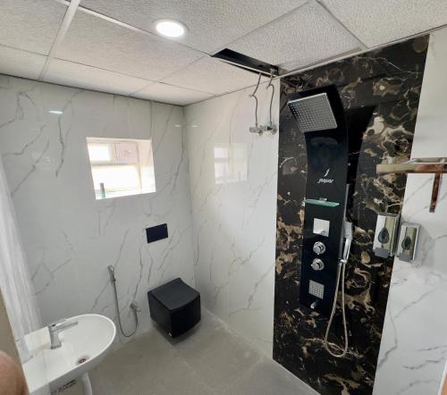 a bathroom with a shower and a sink at Bhoomi mansion Apartment #21 in Bhubaneshwar