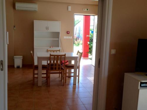 a kitchen and dining room with a table and chairs at Boutique Hotel Ileas Village in Arkoudi