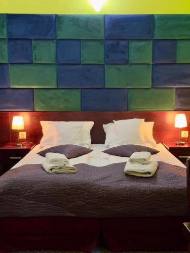 a bedroom with a large bed with two towels on it at EdMar in Malbork