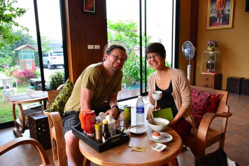 a man and a woman sitting at a table at The Choice Hotel - Adults Only in Bangkok