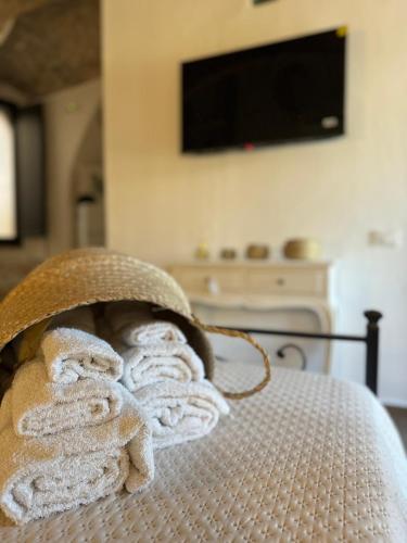 a pile of towels sitting on top of a bed at Les Petites Maisons in Rodi Garganico