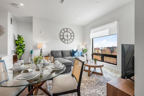 a living room with a table and a couch at Luxury Furnished Apartment Near Logan Airport in Boston