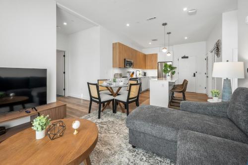 a living room with a couch and a table at Luxury Furnished Apartment Near Logan Airport in Boston