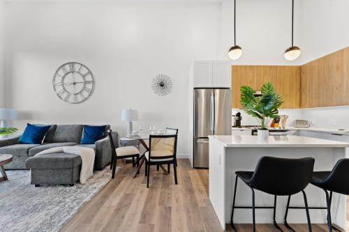 a kitchen and living room with a couch and a table at Luxury Furnished Apartment Near Logan Airport in Boston