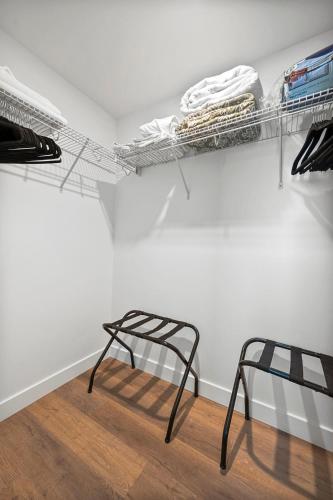 a room with a chair and a white wall at Luxury Furnished Apartment Near Logan Airport in Boston